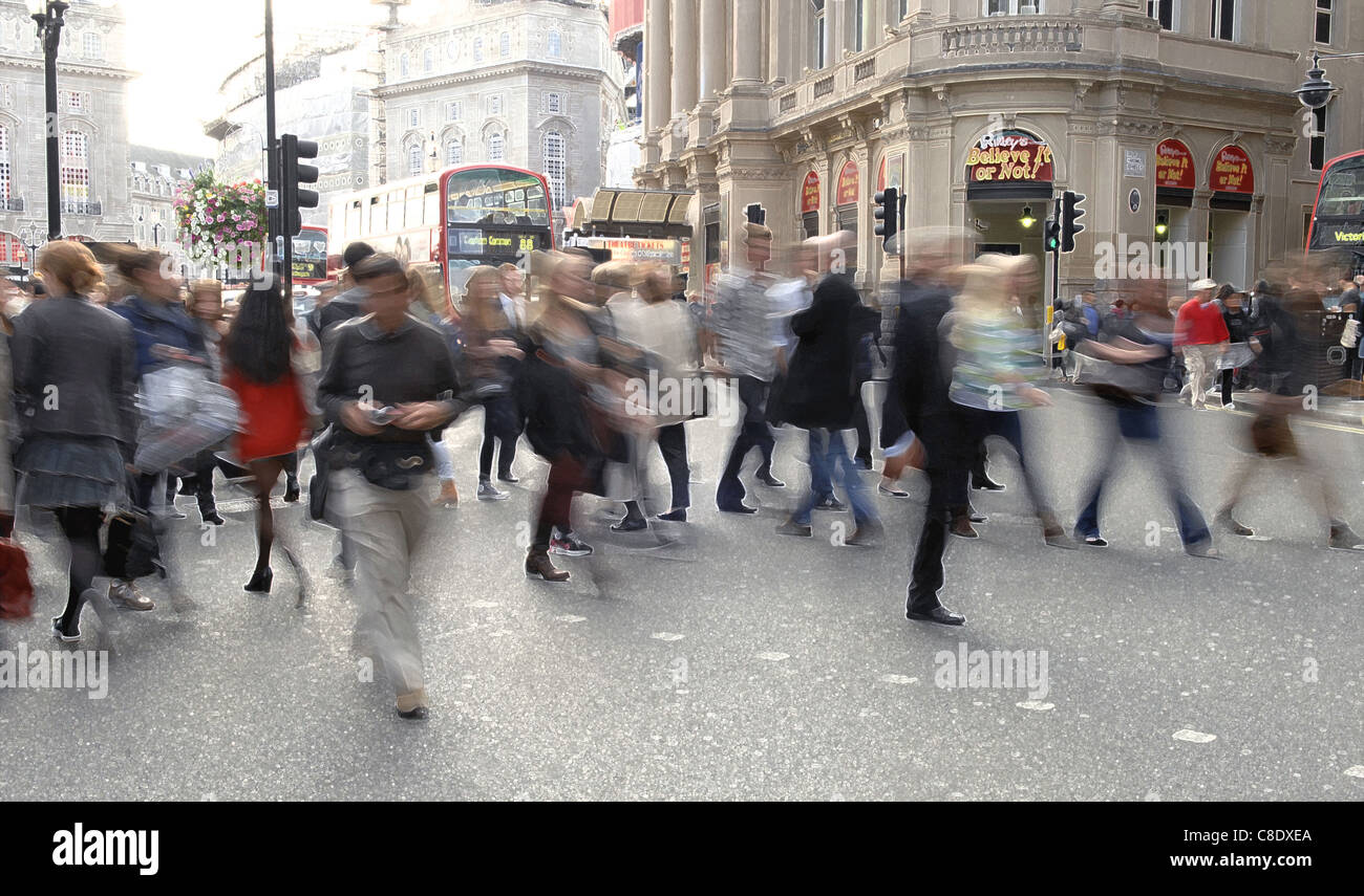 London street scene with tourists and shoppers. Slow exposure and Photoshop treatment to give a vibrant, busy and graphic feel. Stock Photo