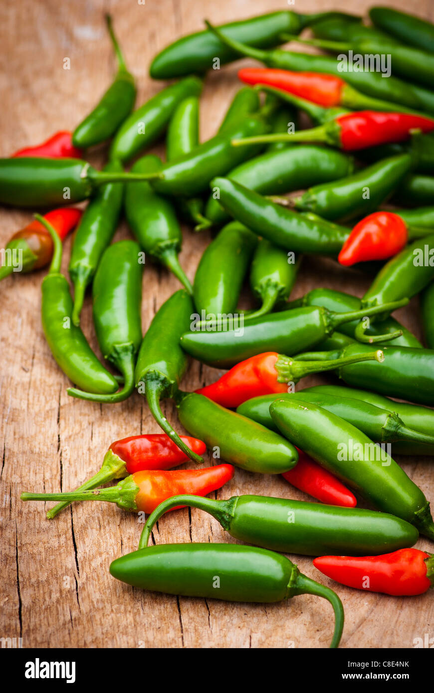 Green and Red Hot peppers on a wooden background Stock Photo - Alamy