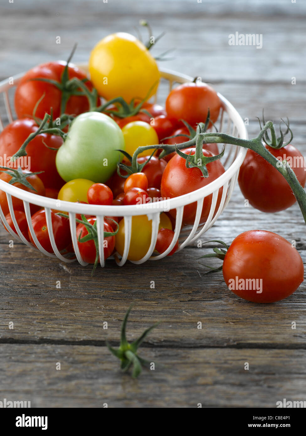 Basket of assorted tomatoes Stock Photo - Alamy