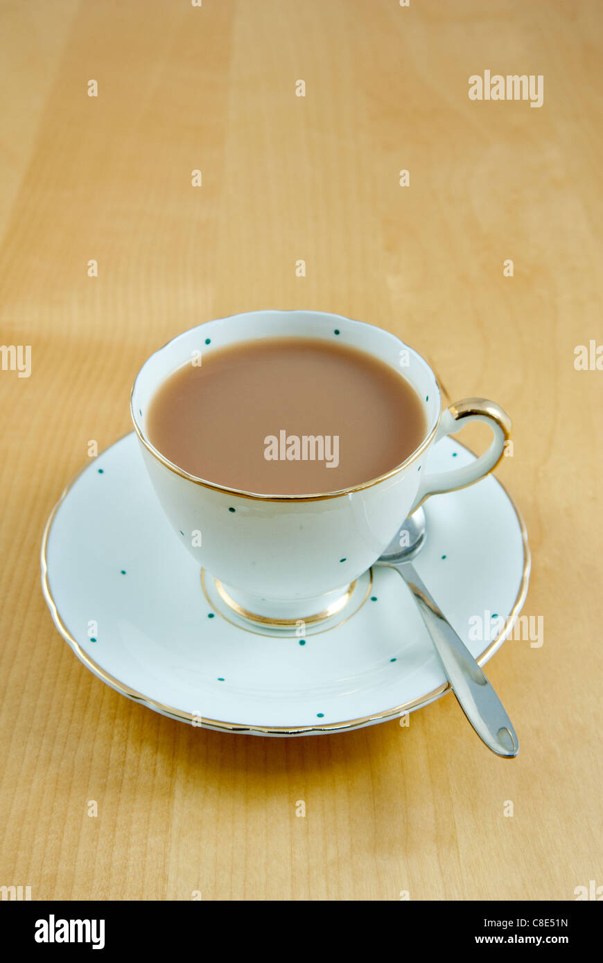 A cup of tea with milk in a bone china cup and saucer. Stock Photo