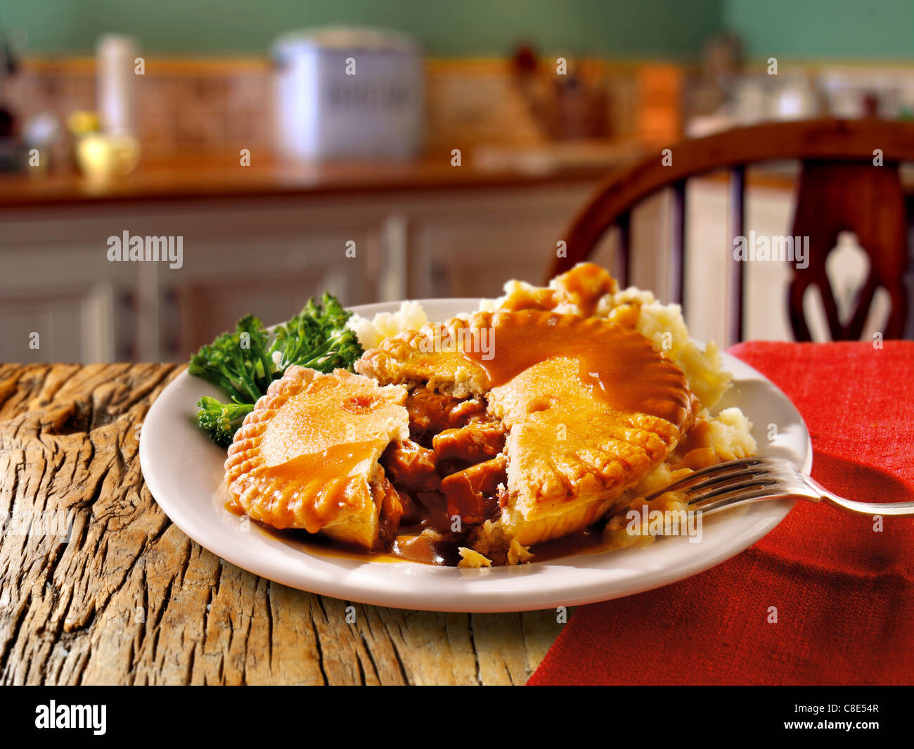 Traditional British beef pastry pie served on a white plate on a table