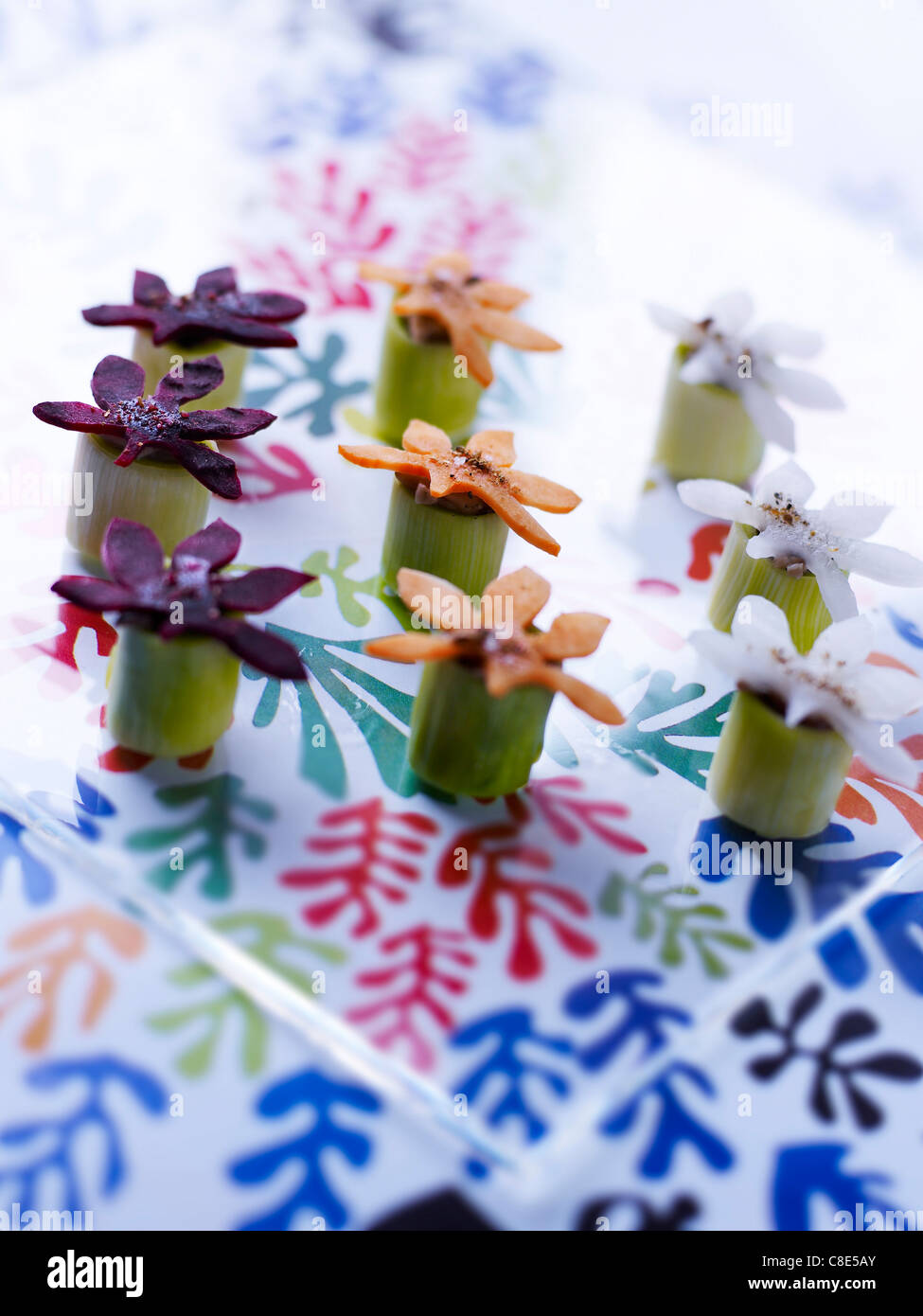 Small leek and flowershaped vegetable appetizers Stock Photo Alamy