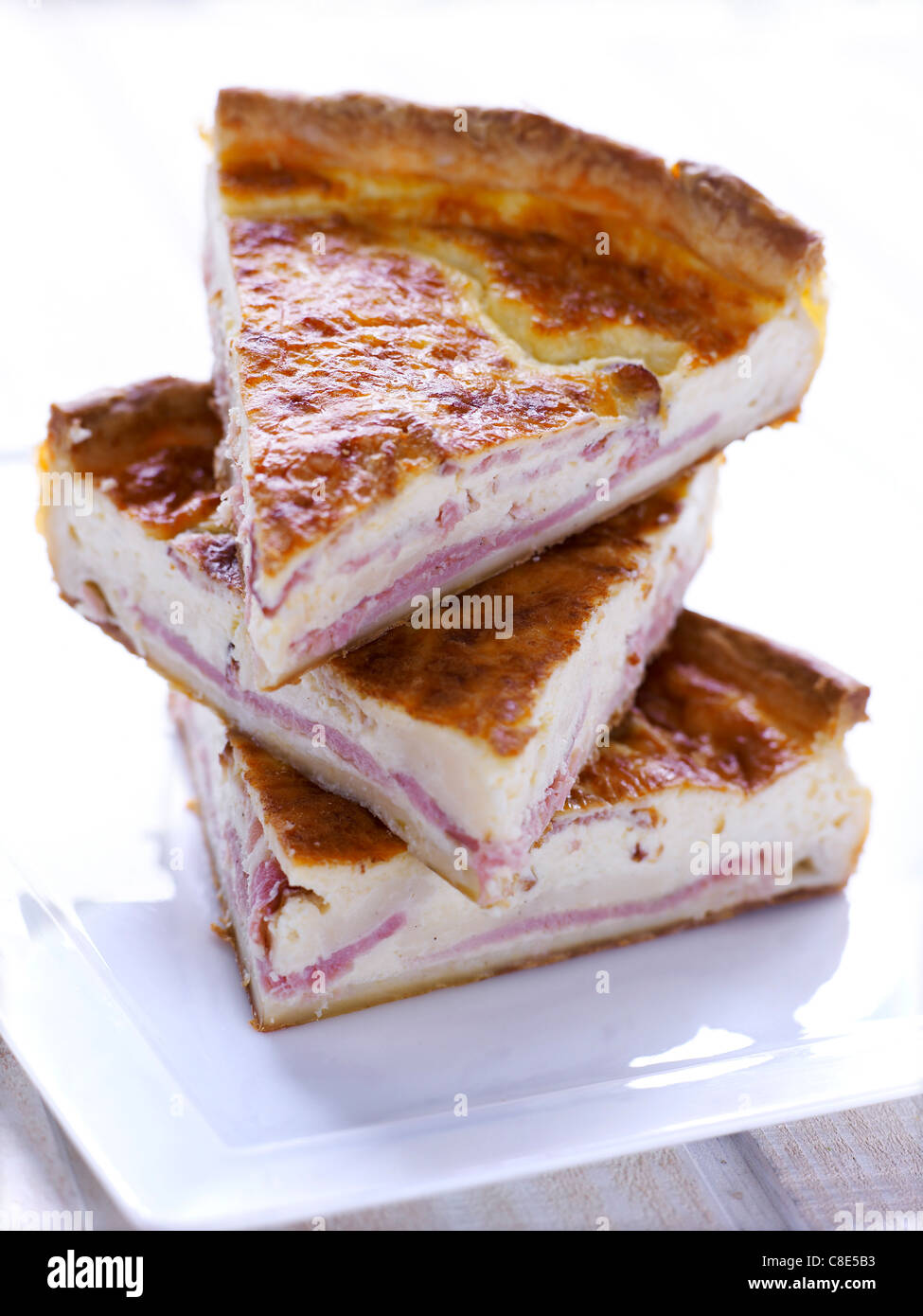Stacked portions of cheese and ham quiche Stock Photo