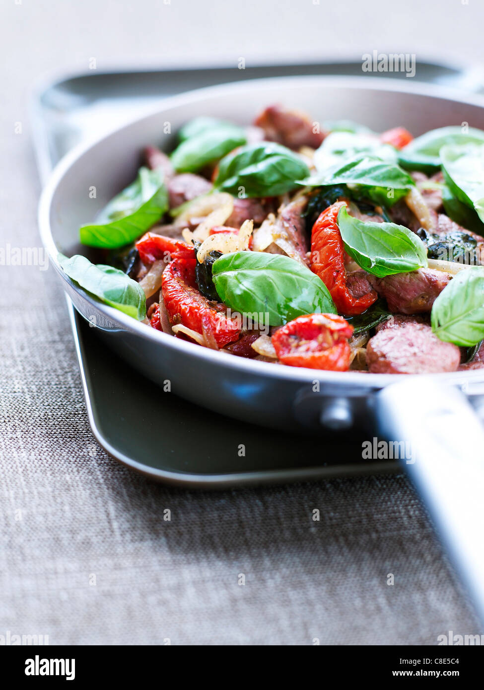 Lamb,basil and sundried tomato stirfry Stock Photo Alamy