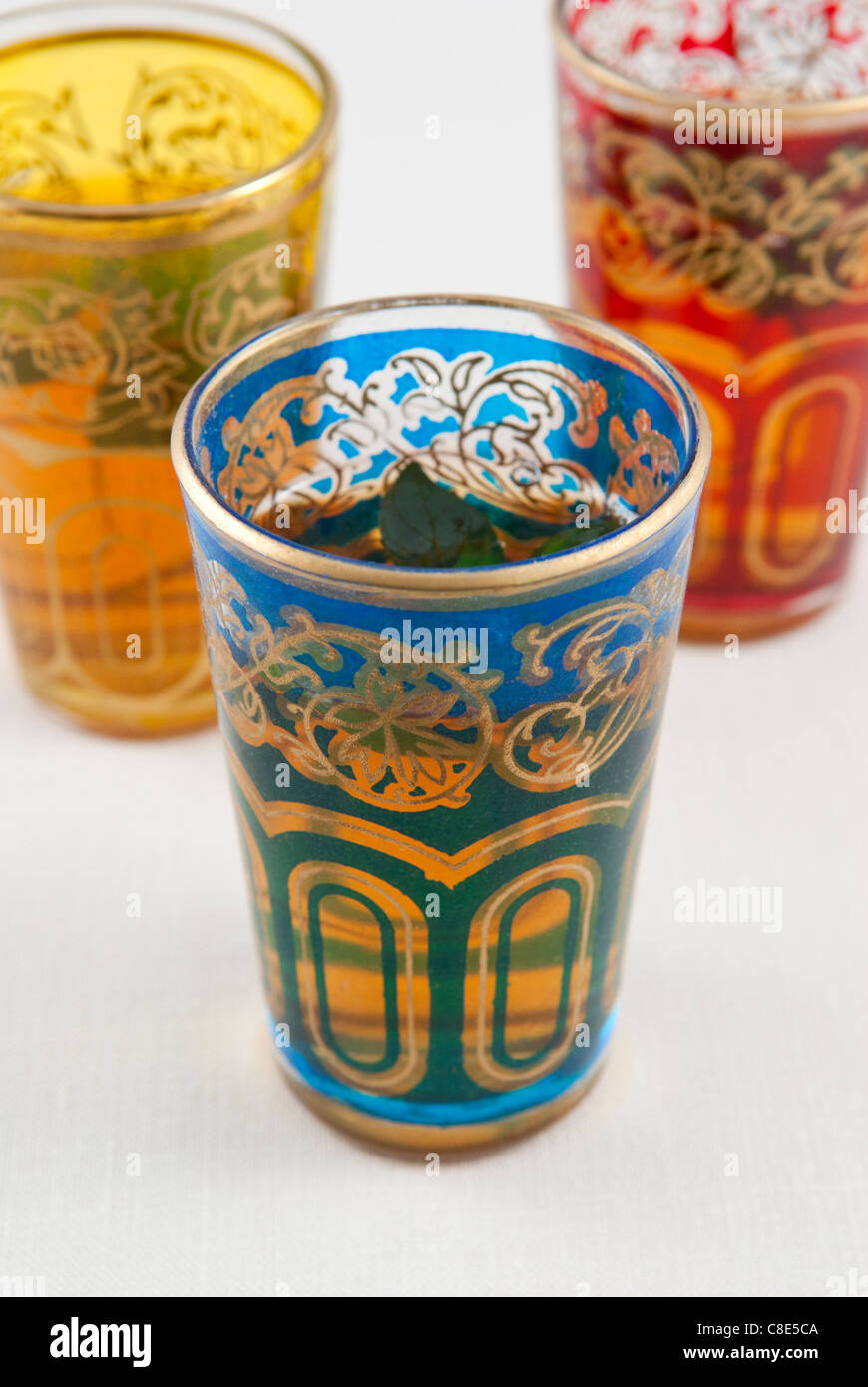 Small coloured glasses of mint tea on a white background. Stock Photo