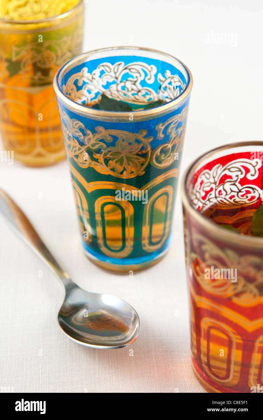 Small coloured glasses of mint tea on a white background. Stock Photo