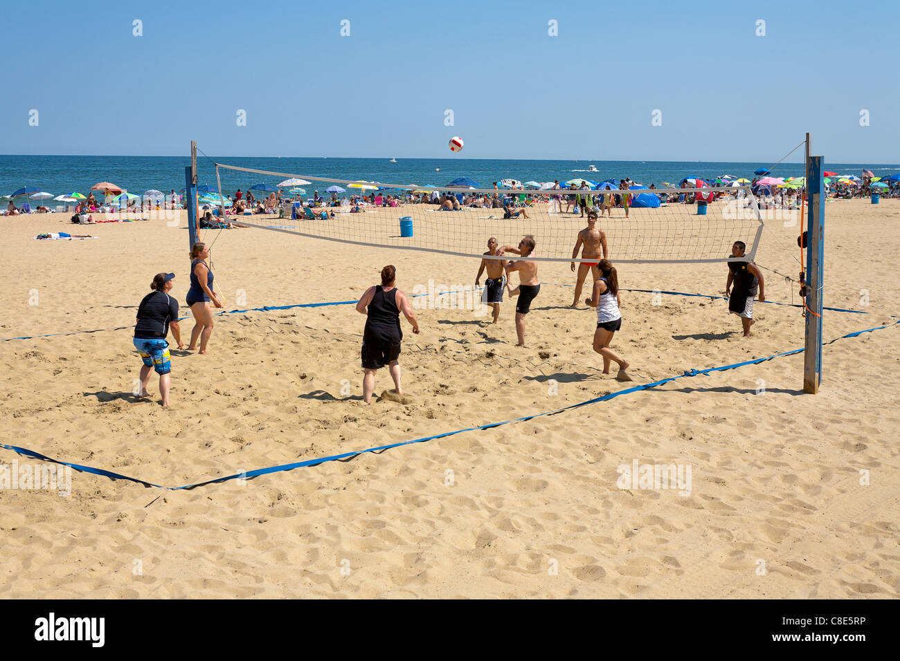 Playing volleyball on the beach. Stock Photo