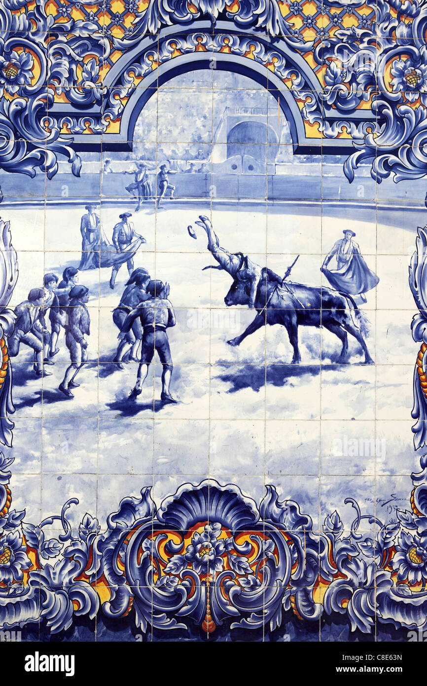 Painted tiles (Azulejos) shows a team of Forcados in action in a bullfighting scene in Santarem, Ribatejo, Portugal. Stock Photo