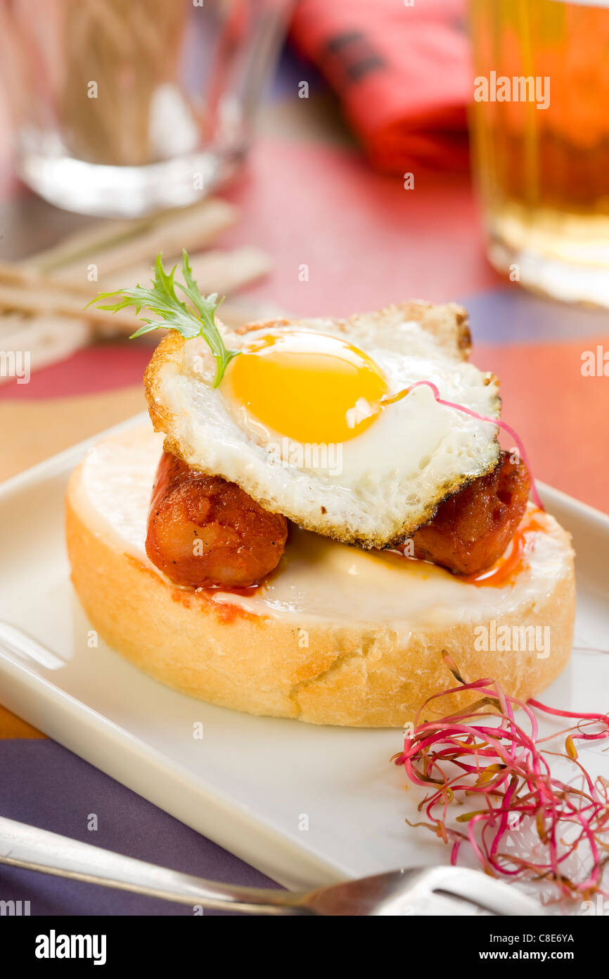 Chistorra and fried quail's egg open sandwich Stock Photo