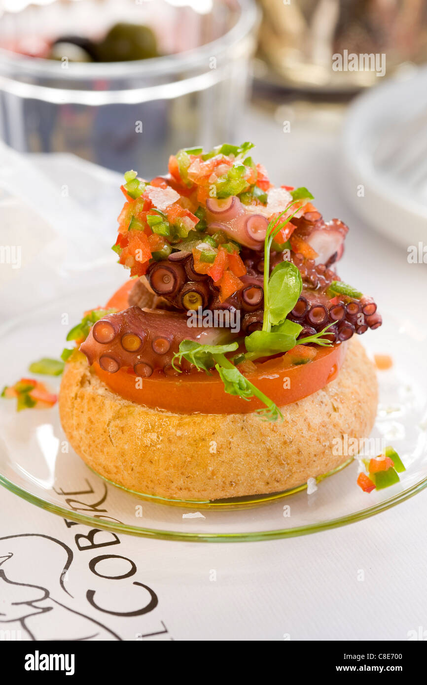 Tomato and octupus with french dressing open sandwich Stock Photo