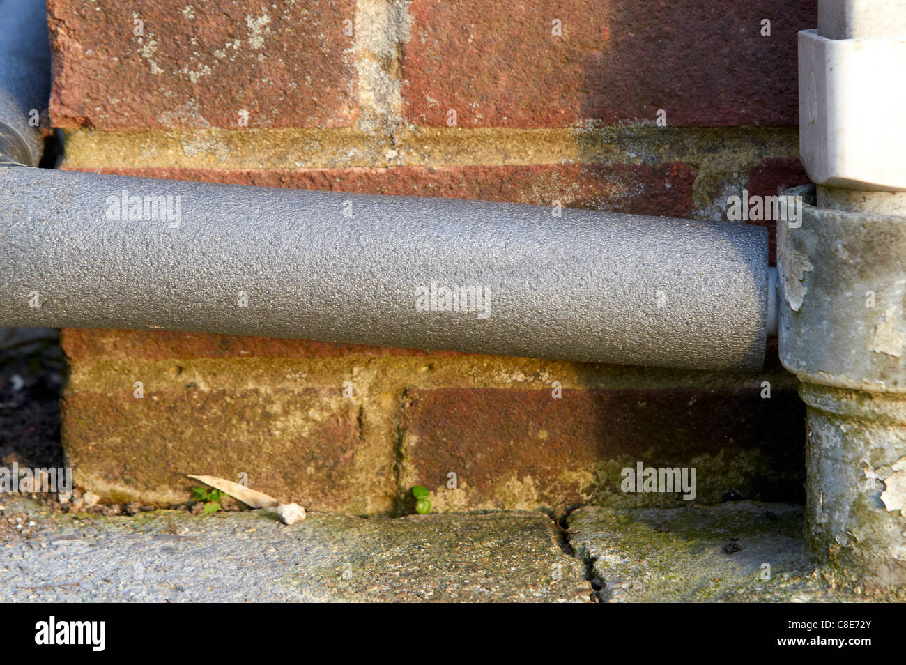 Condensate pipe from a condensing boiler lagged to prevent the pipe freezing up in cold winter conditions. Stock Photo