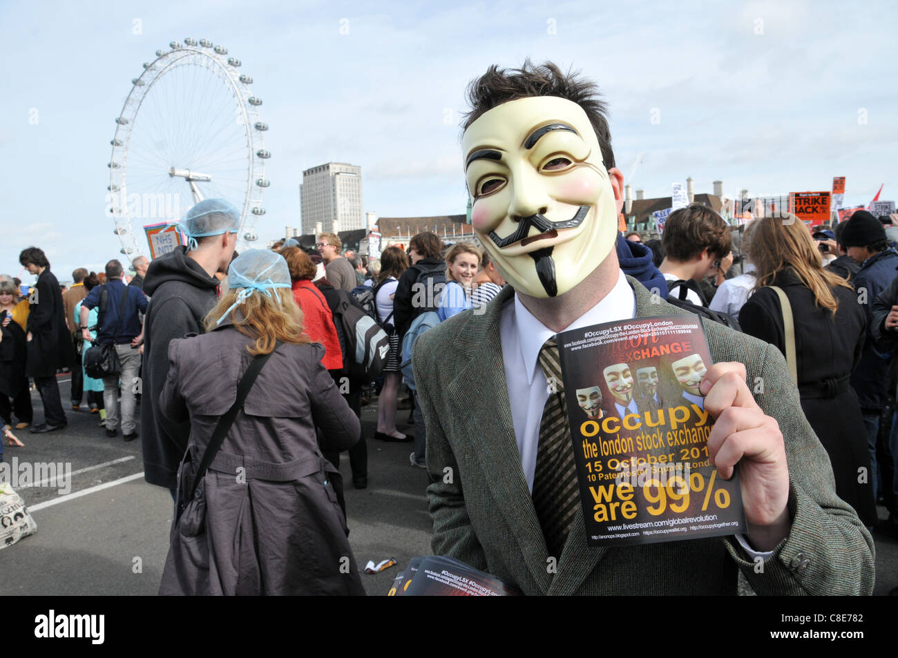 Anonymous UK Guy Fawkes V for Vendetta masked Occupy London 99% activist on Westminster Bridge Stock Photo