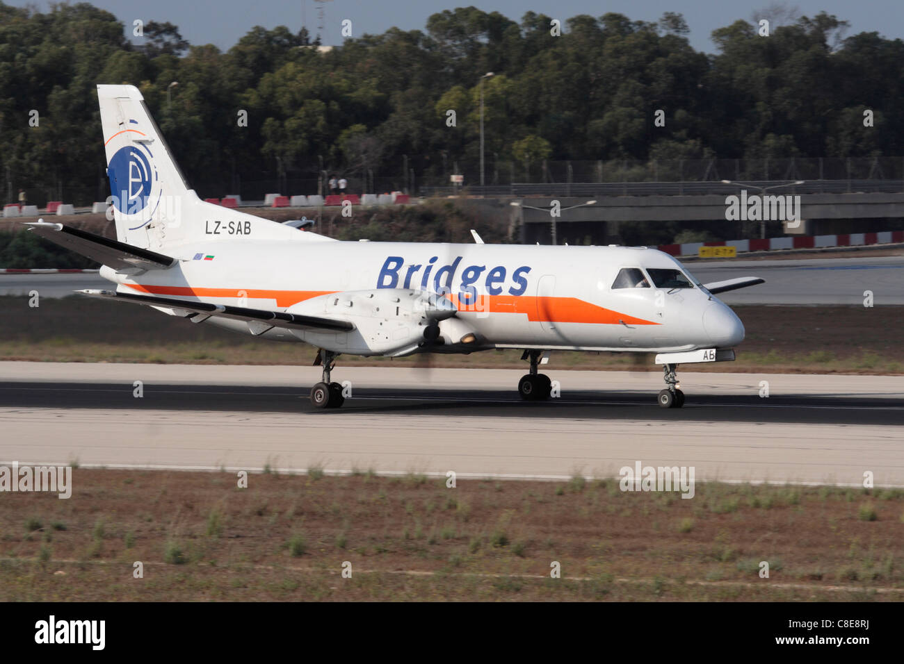 Bridges Worldwide Saab 340 cargo plane on the runway during takeoff from Malta Stock Photo