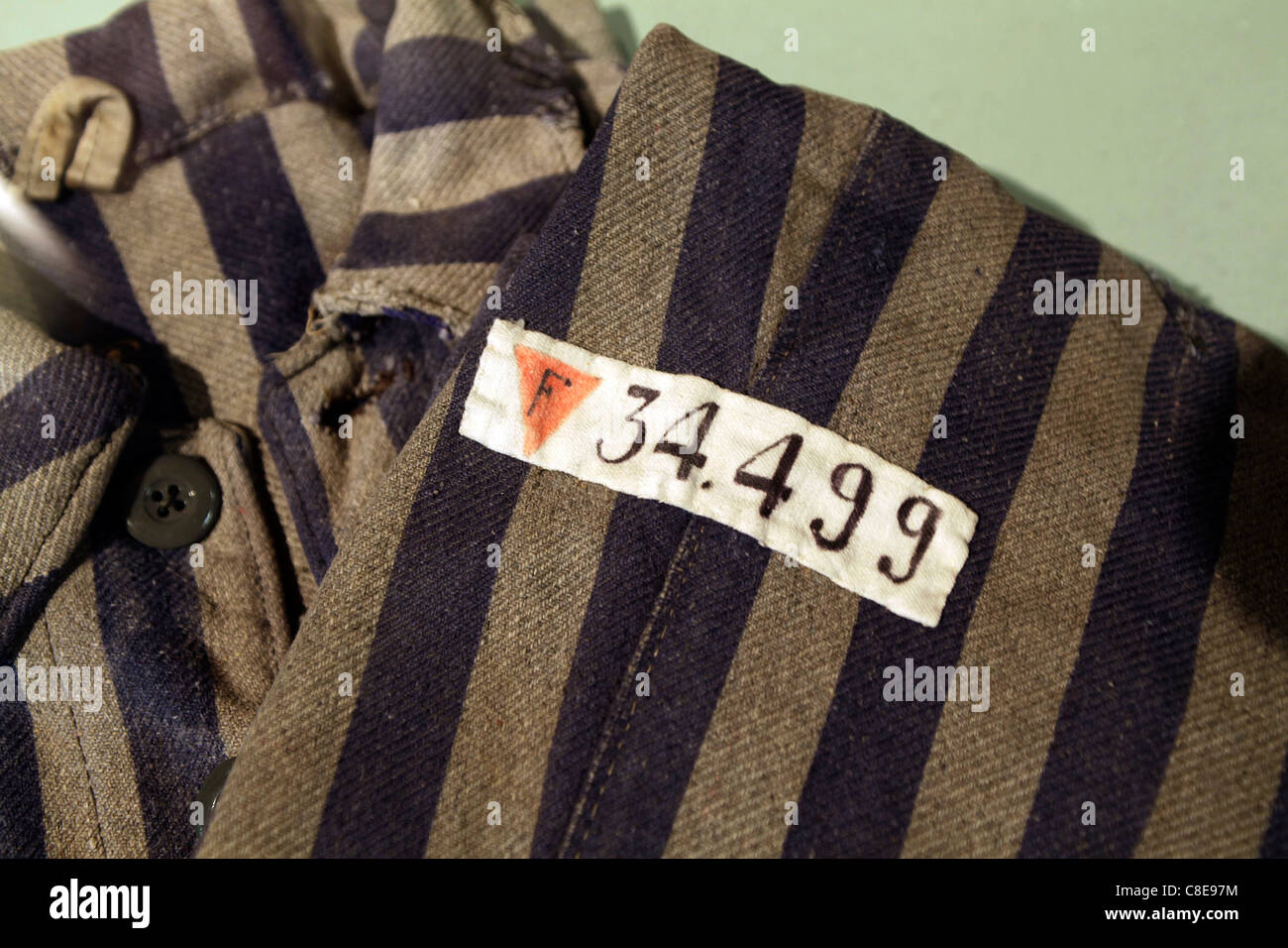 World War 2 Concentration Camp Uniform from Dachau. The red triangle indicates a political prisoner. Stock Photo