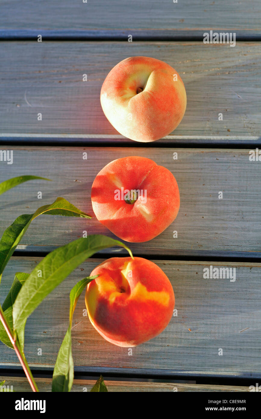 Three peaches in a row Stock Photo
