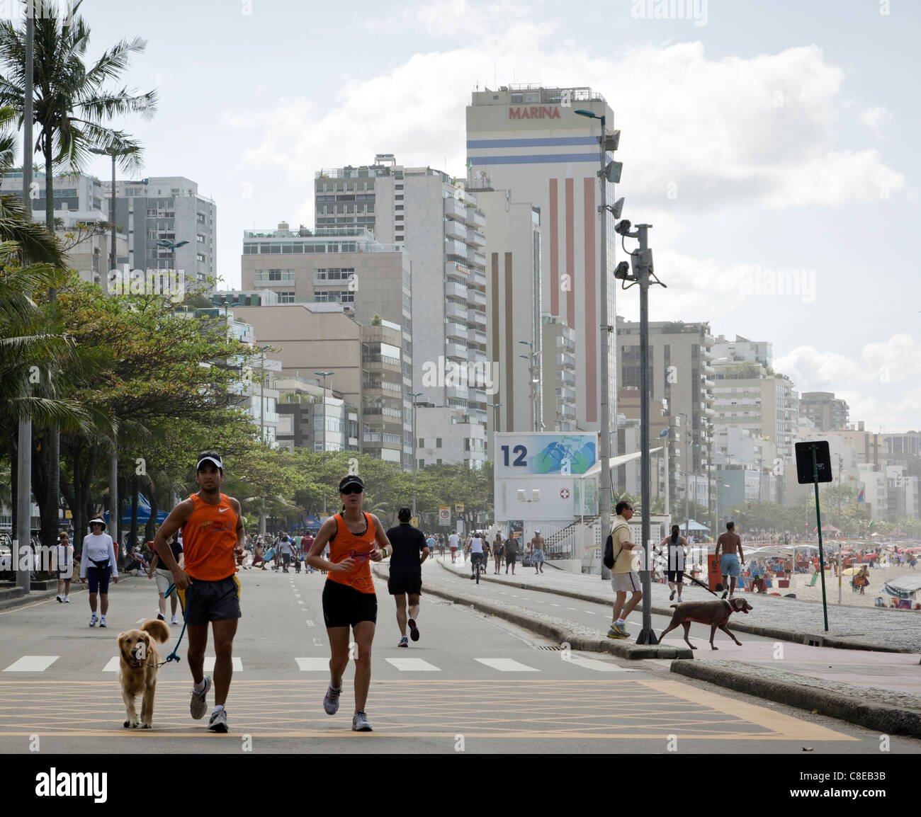 Couple jogging alongside Leblon beach (Posto 12) Rio de Janeiro, Brazil Stock Photo