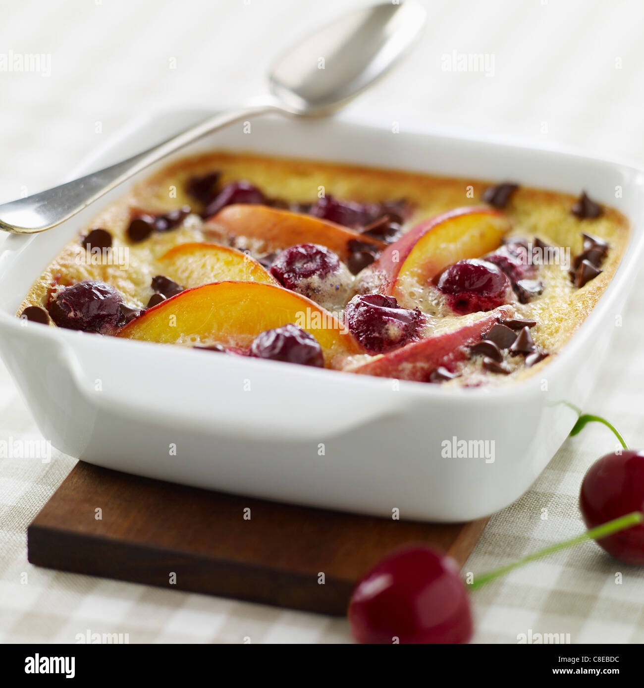 Nectarine,cherry and chocolate chip batter pudding Stock Photo Alamy