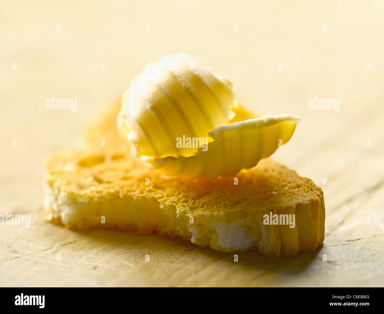 Knob of butter on a piece of biscotte Stock Photo Alamy