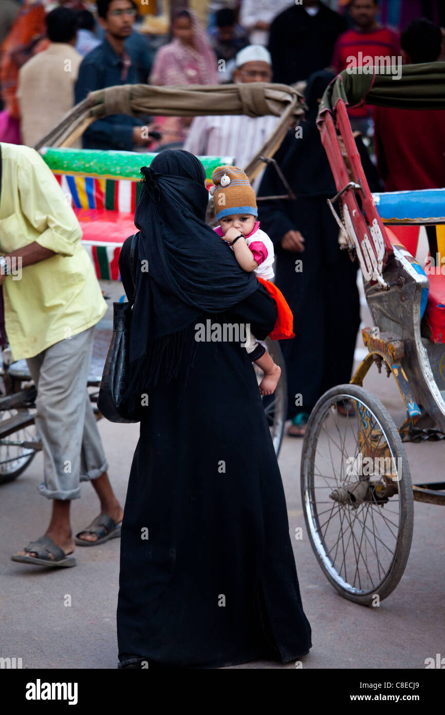 Muslim woman and child out shopping in city of Varanasi, Benares, Northern India Stock Photo