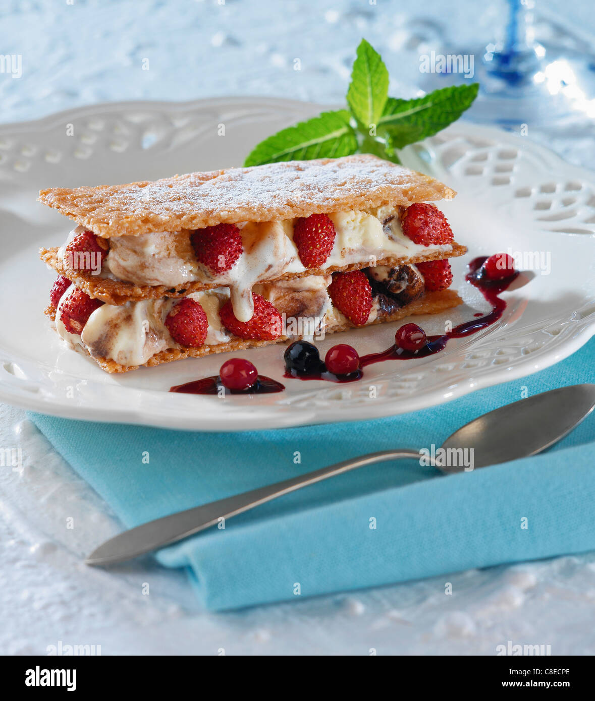 Wild strawberry and cream Millefeuille with summer fruit puree Stock