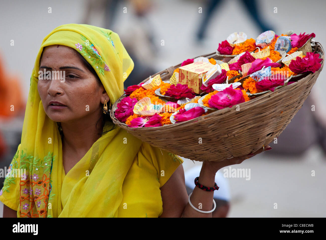 Indian Hindu woman selling ceremonial flowers and offerings during