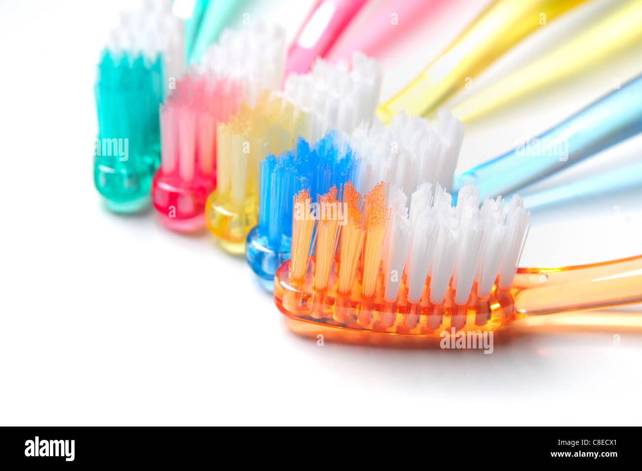 Five multicolored toothbrushes on white background Stock Photo - Alamy