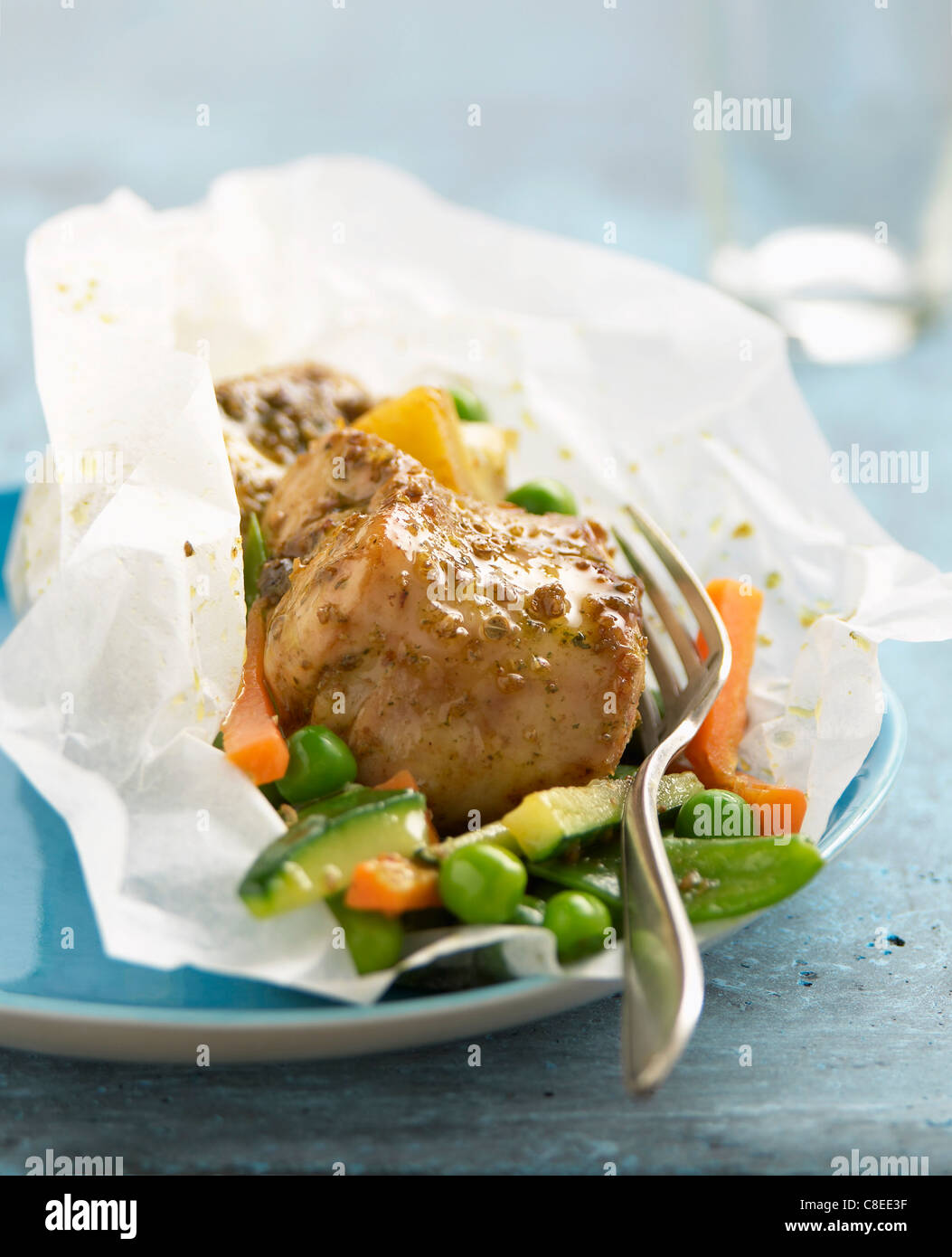 Rabbit with coriander,lemons and vegetables cooked in wax paper Stock