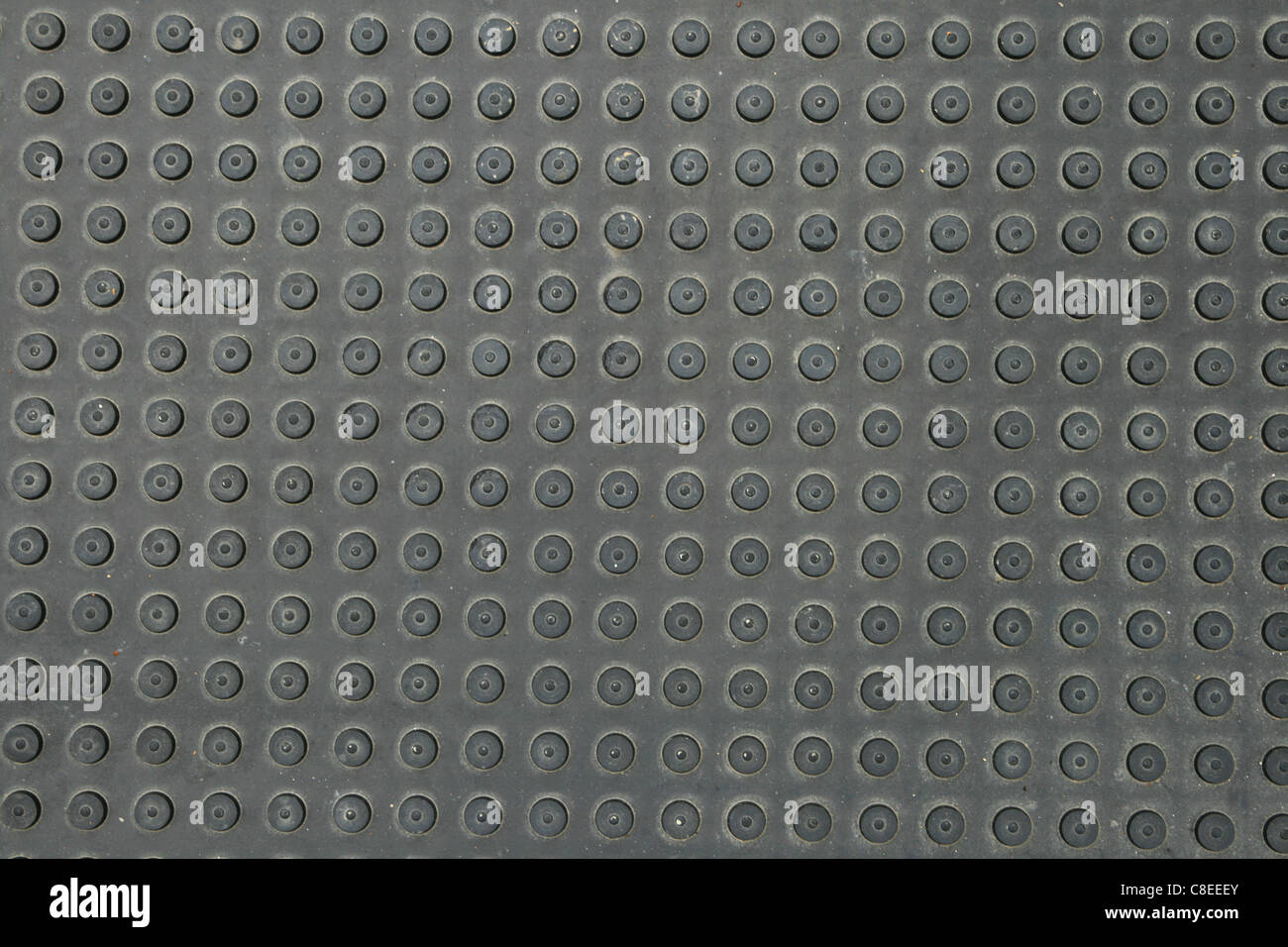 black rubber mat with round bumps in rows for background texture Stock Photo