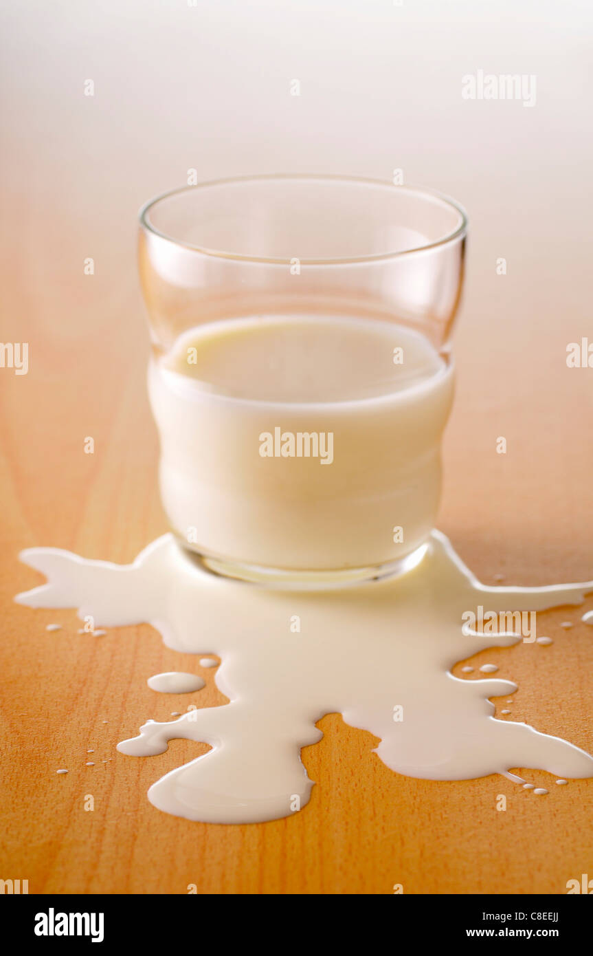 Spilt glass of milk Stock Photo
