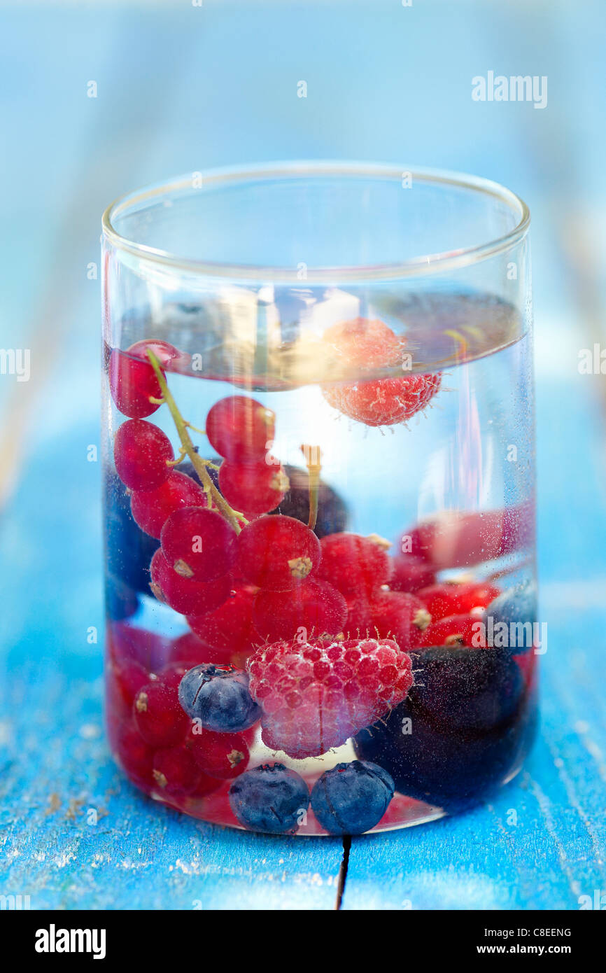 Summer fruit in a glass of water Stock Photo
