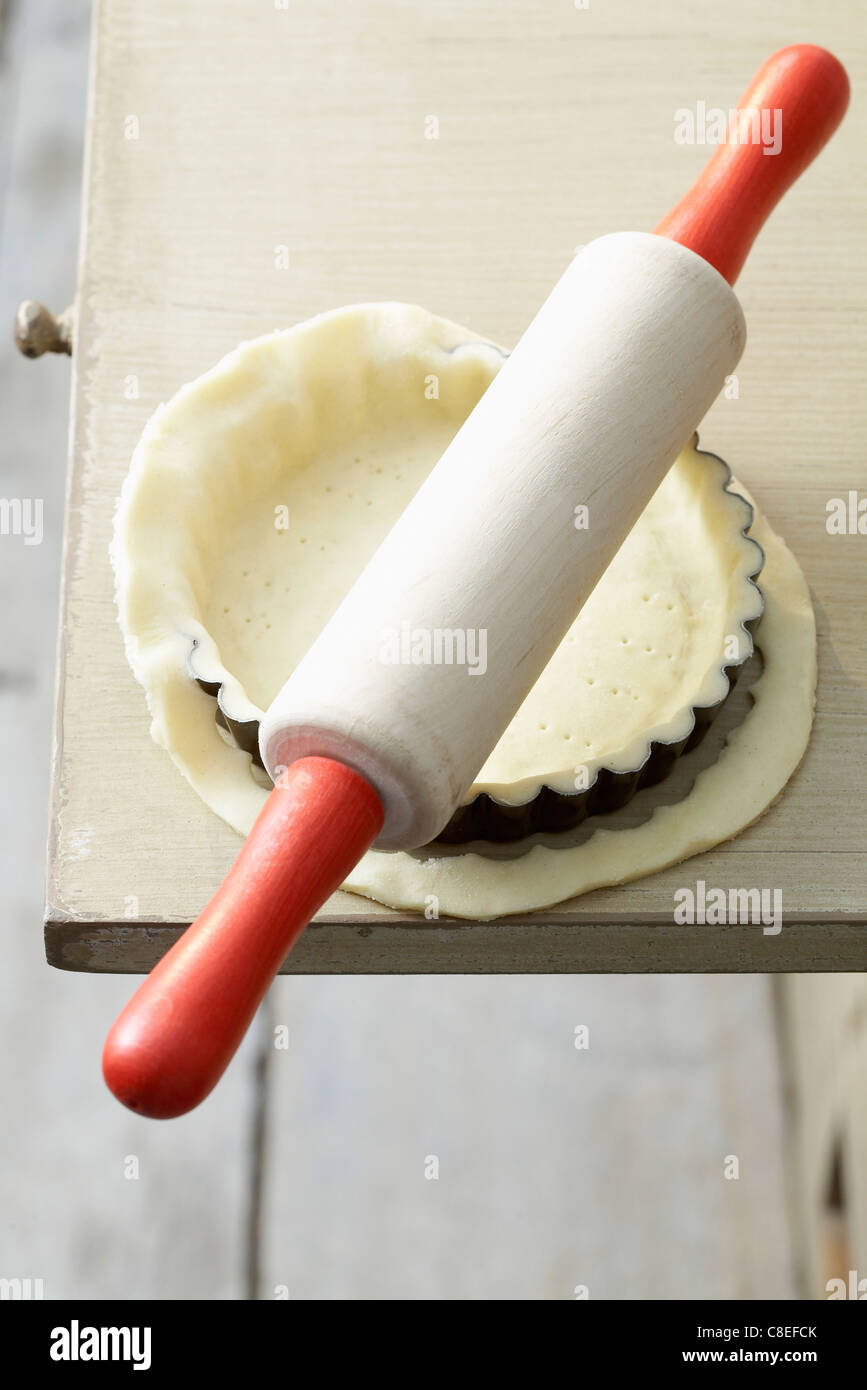 Removing the extra pastry with a rolling pin Stock Photo Alamy