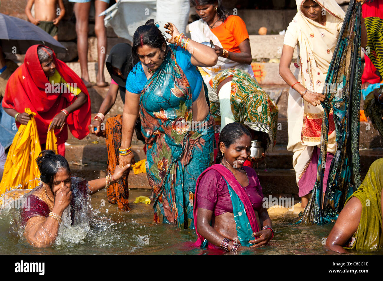 Hindu pilgrims bathing in The Ganges River at Dashashwamedh Ghat in Holy Ci...