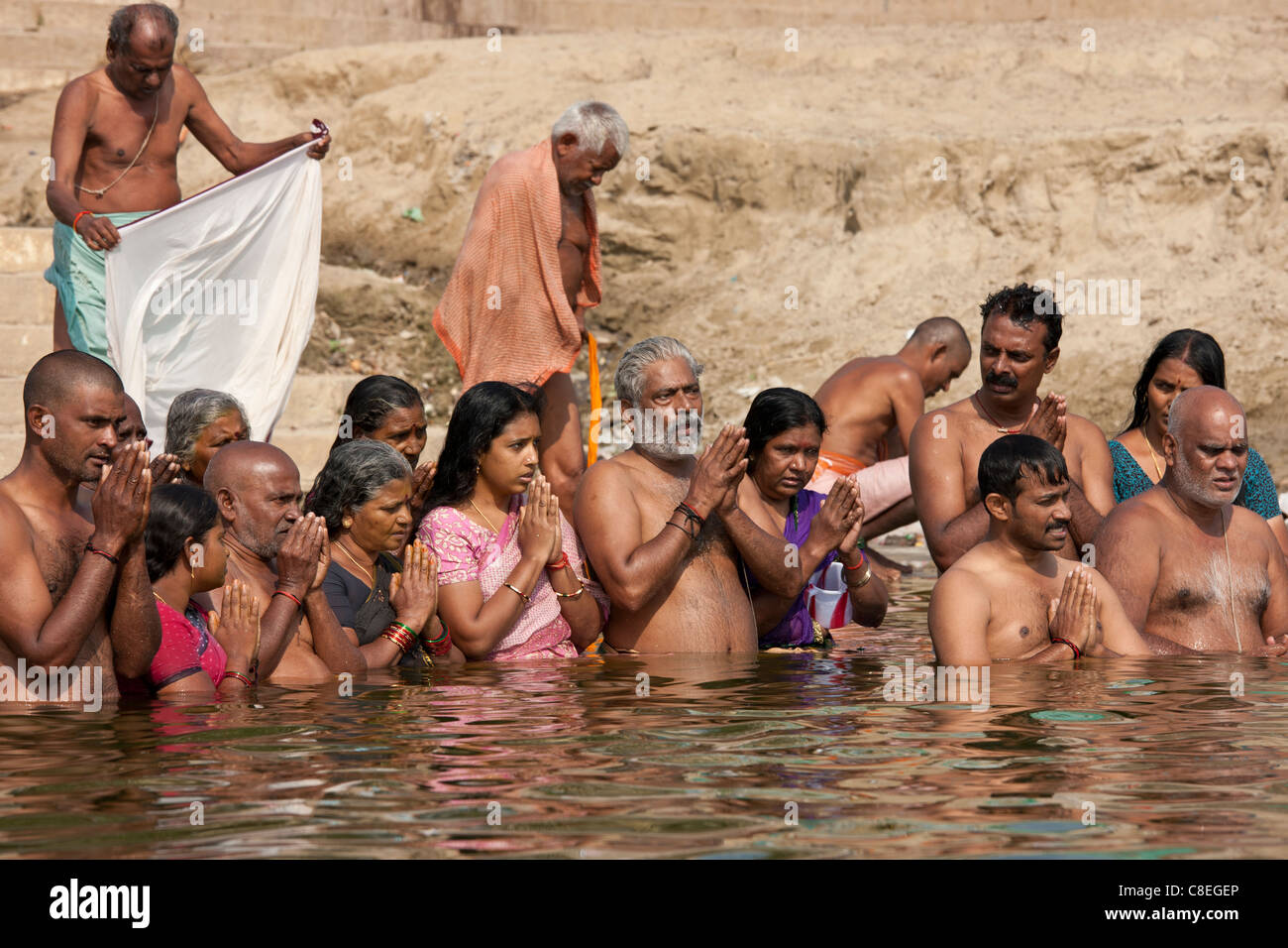 Indian Hindu men and women bathing and praying in the River Ganges by Kshameshwar Ghat in holy city of Varanasi, India Stock Photo