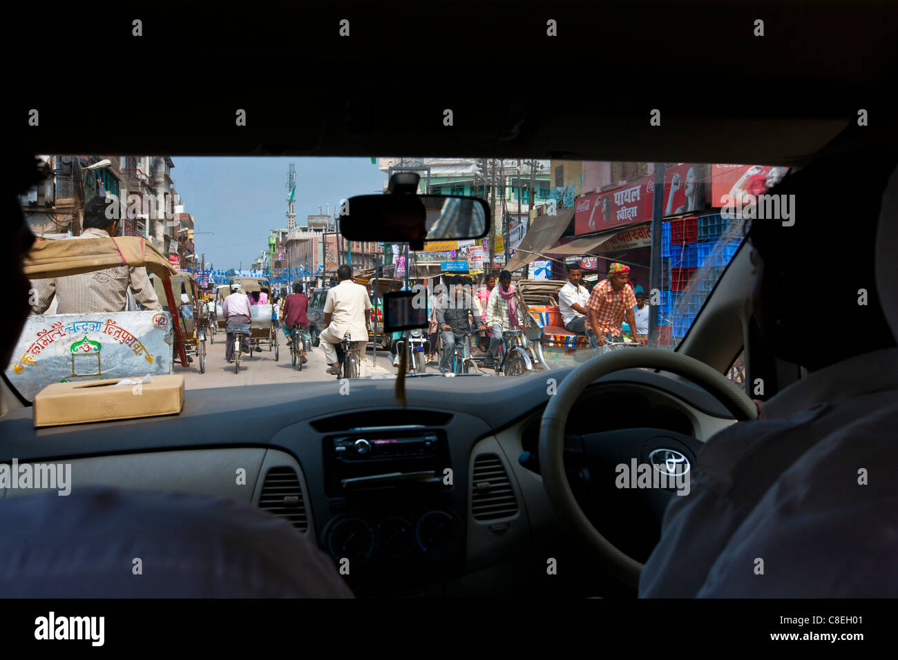Busy street scene viewed through taxi windscreen in city of Varanasi, Benares, Northern India Stock Photo