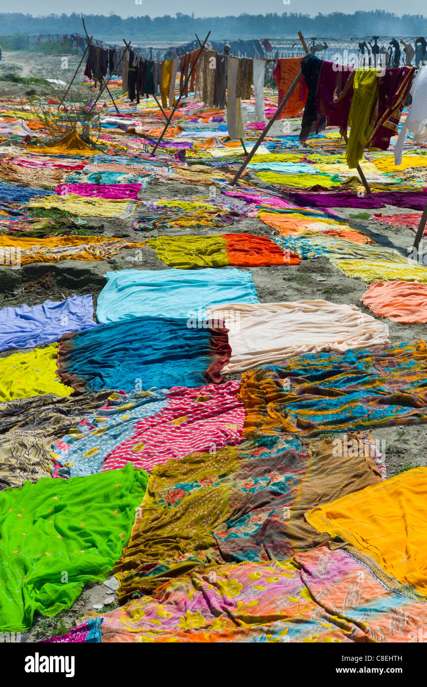 Saris and other laundry drying on the banks of River Yamuna at Agra, India Stock Photo