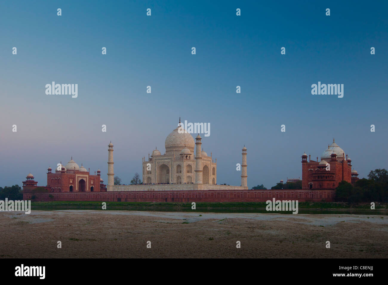 The Taj Mahal and Mosque North Side viewed across Yamuna River at sunset , India Stock Photo