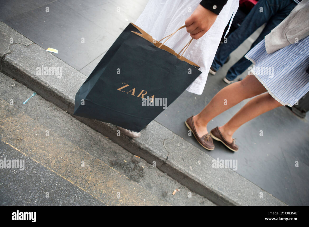 person walking with Zara shopping bag in city town low section Stock Photo  - Alamy