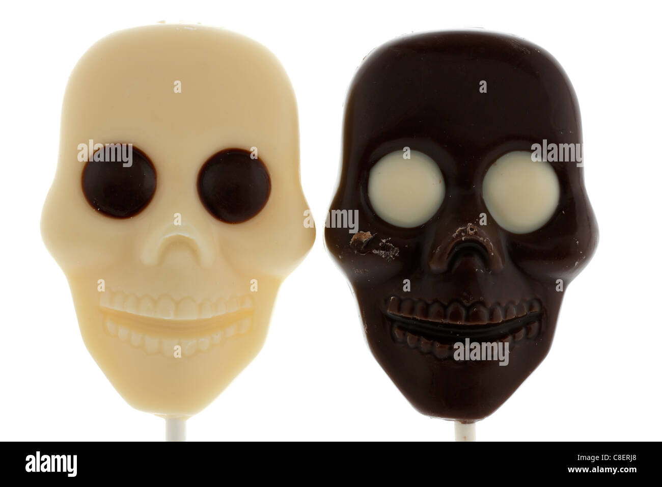 Two Halloween chocolate skulls on sticks Dark and white chocolate Stock Photo