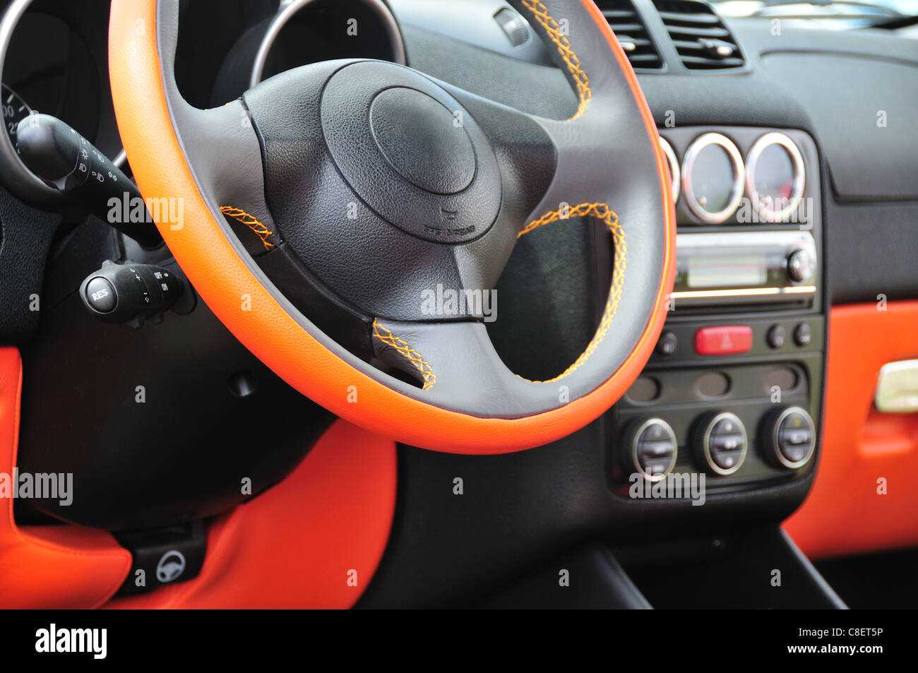 Modern car interior with orange steering wheel Stock Photo Alamy