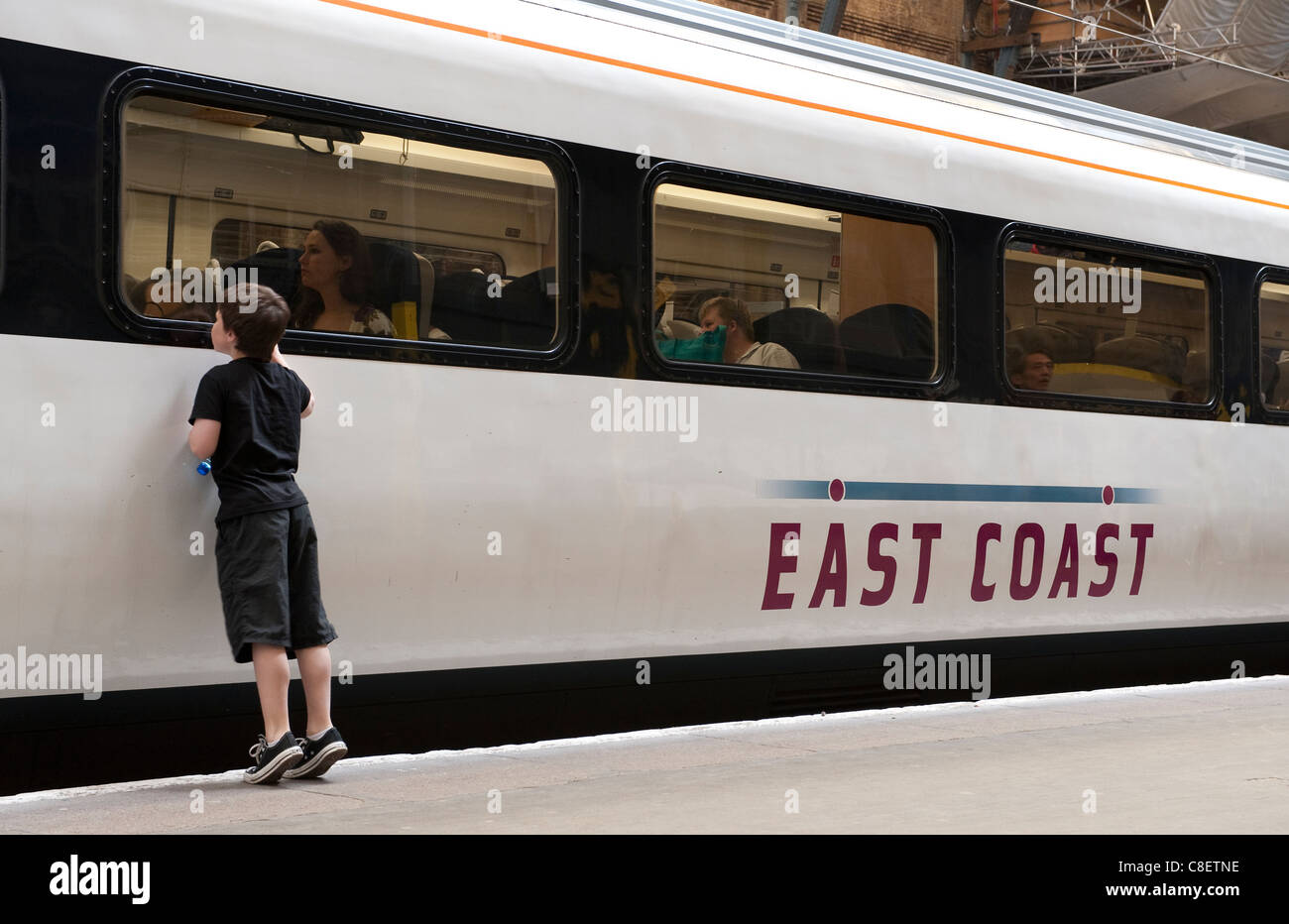 Child looking through the window of an East Coast Trains train at Kings
