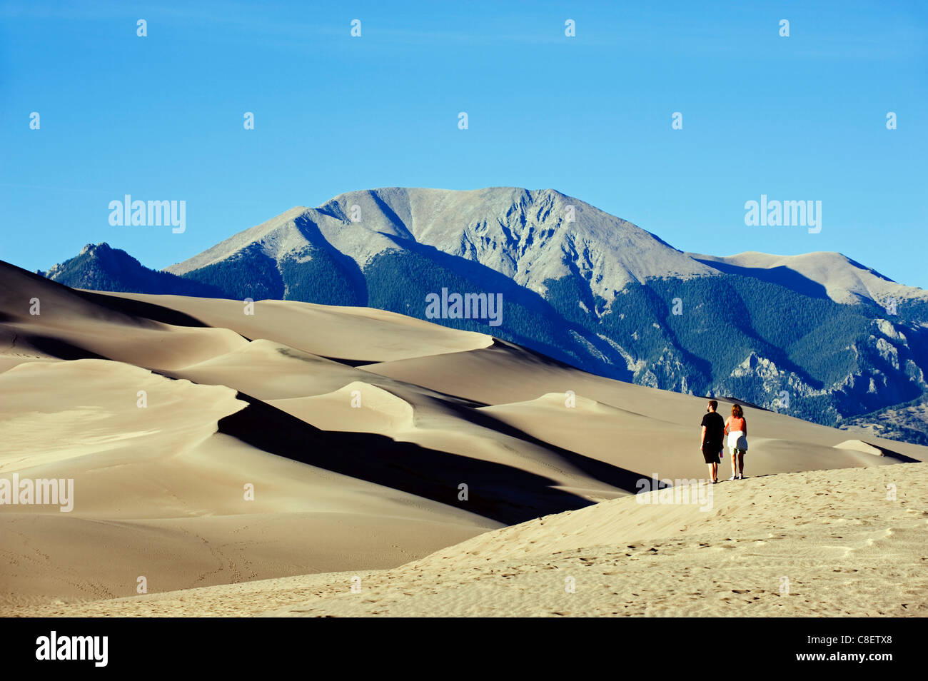 Couple walking in Great Sand Dunes National Park, Colorado, United States of America Stock Photo
