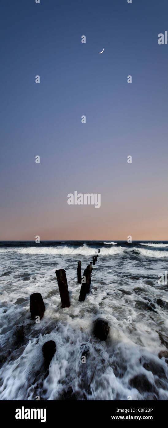 Moon rise over surf Stock Photo