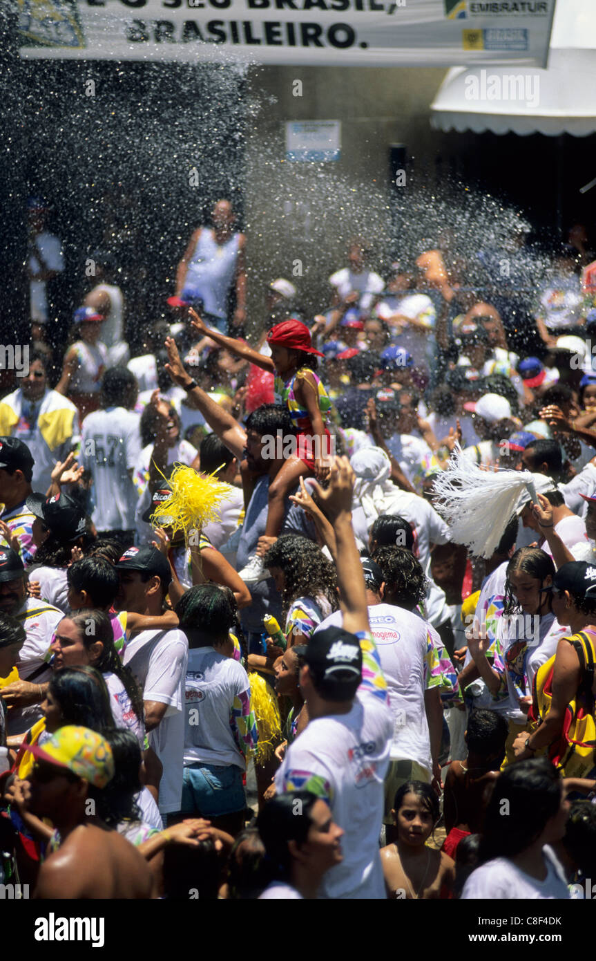 Salvador, Brazil. Crowd of people enjoying a refreshing shower of water ...