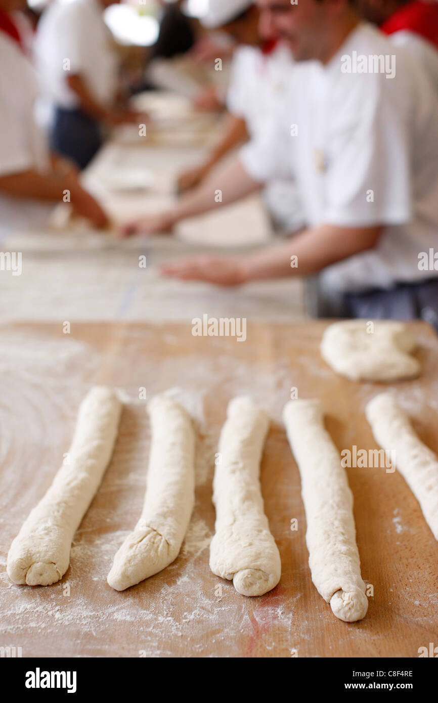 Bakers making loaves of bread (baguettes, Paris, France Stock Photo