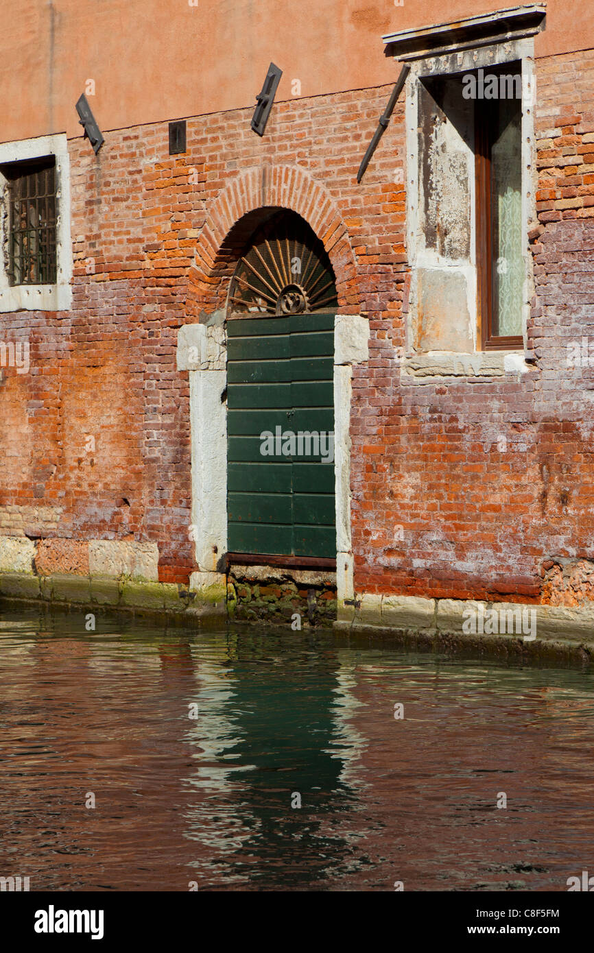Back door entrance to a building, direct from the canal, in Venice Stock Photo
