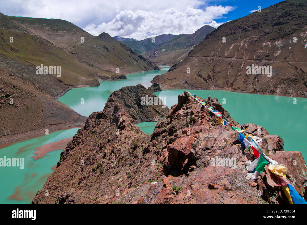 Praying flags above an artifical lake near the Karo-La Pass, Tibet, China Stock Photo