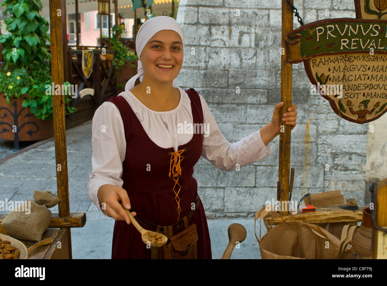 Traditionally dressed girl selling stuff from the Middle Ages, Tallinn, Estonia, Baltic States Stock Photo