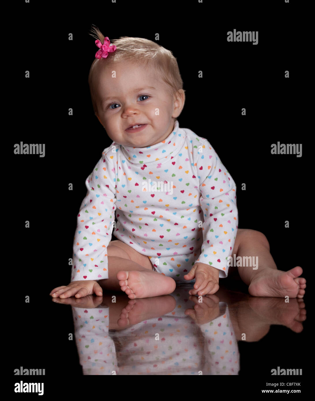 A cute image of a beautiful baby girl with a pink flower bow in her ...