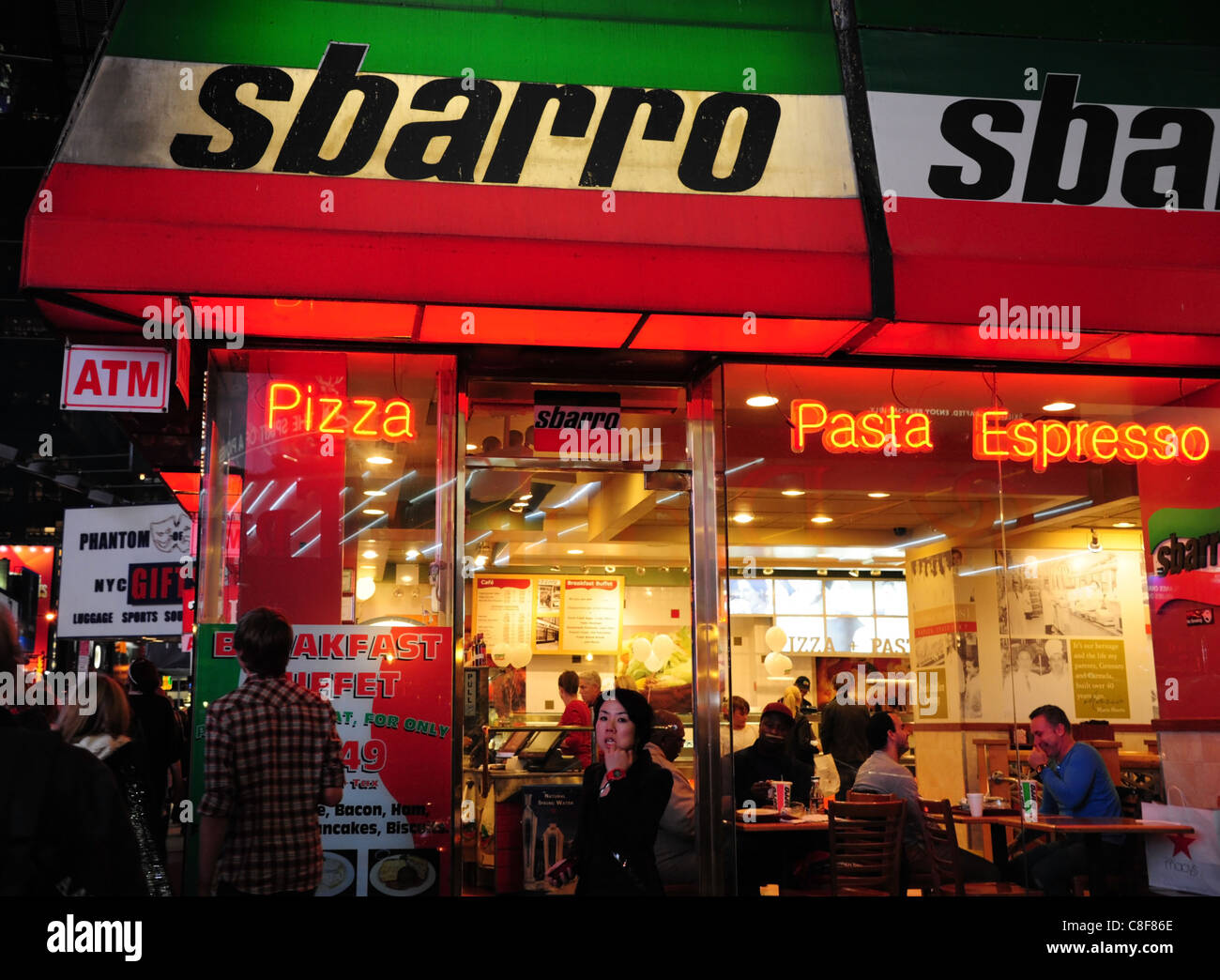 Night shot people walking dining eating red white green neon Sbarro ...