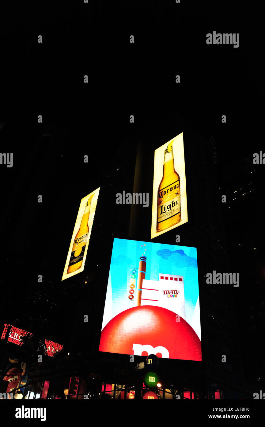 Night shot large blue red neon screen image advertising M&M sweets, M&M World Candy Store, 7th Avenue, Times Square, New York Stock Photo
